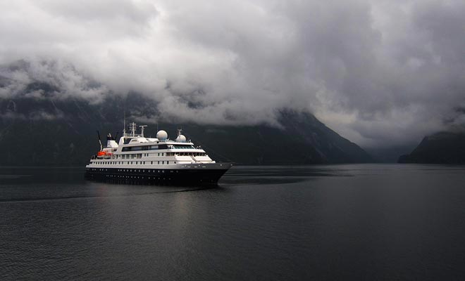 Cruise ships criss-cross the waters of the fiord with a few sailboats.