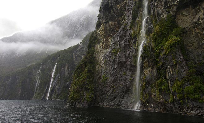 When the rain stops and one can finally enjoy the landscape, one discovers hundreds of waterfalls that pour into the dark waters of the fjord.