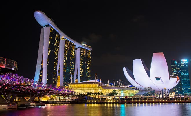 Marina Bay Sands is a large resort with a pool at the top of a skyscraper. With the multicolored illuminations at nightfall, the view is spectacular.