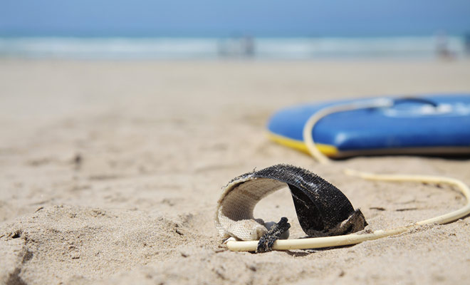 It would be easy to have your surfboard washed away by the waves, but the leash connects you to it permanently.