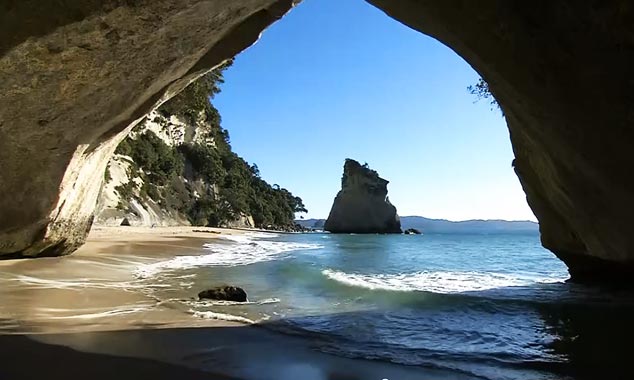On the other side of the arch, the beach continues.