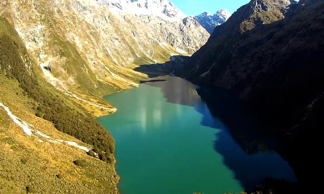 Flying over the Fiordland by helicopter to Milford Sound.