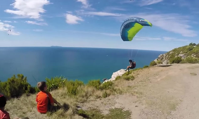 Fly over the ocean by paragliding.